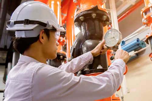 photo of woman conducting an air compressor energy audit